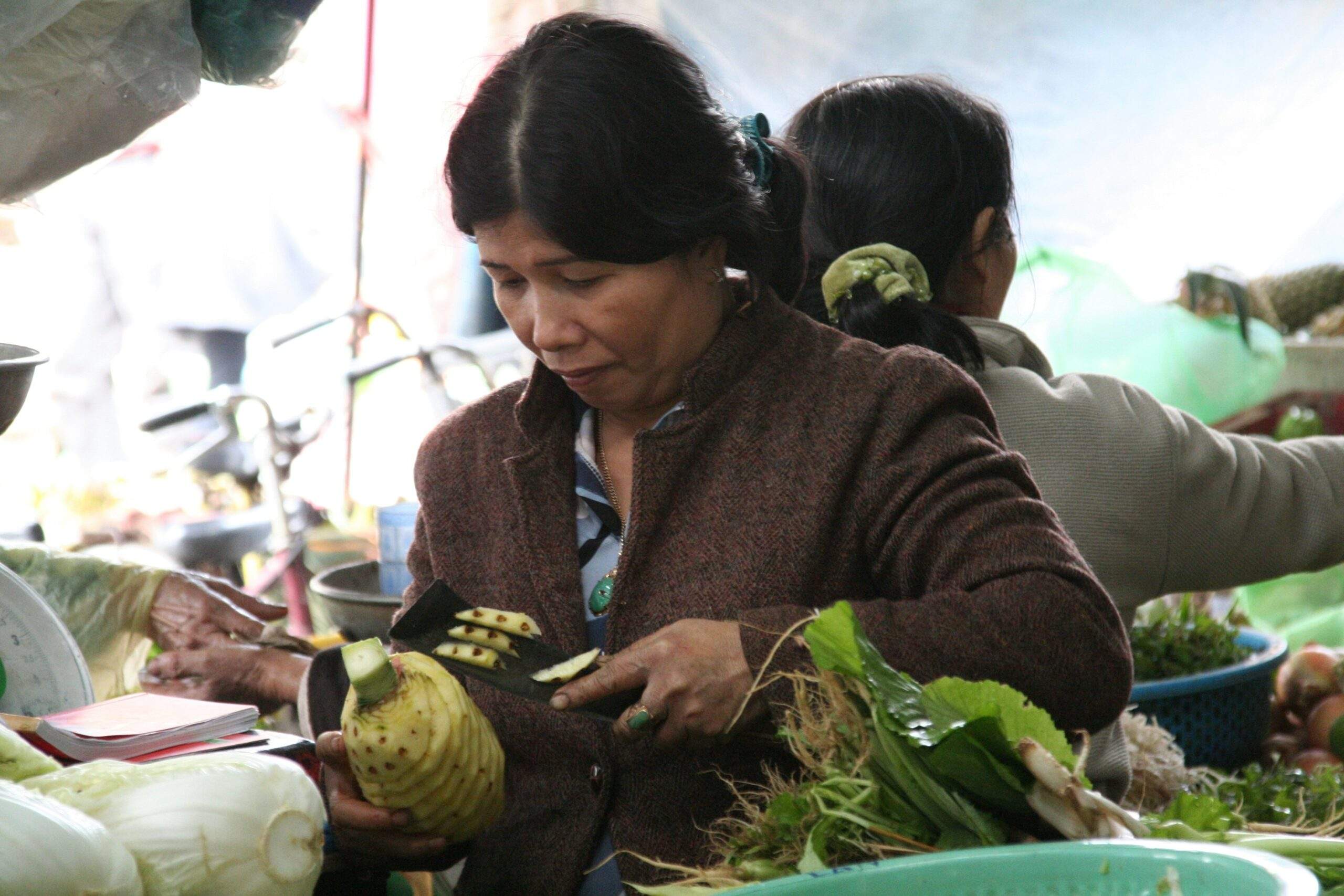A woman holding a reusable glass jar filled with homemade organic face mask made from avocado, honey, and lemon.