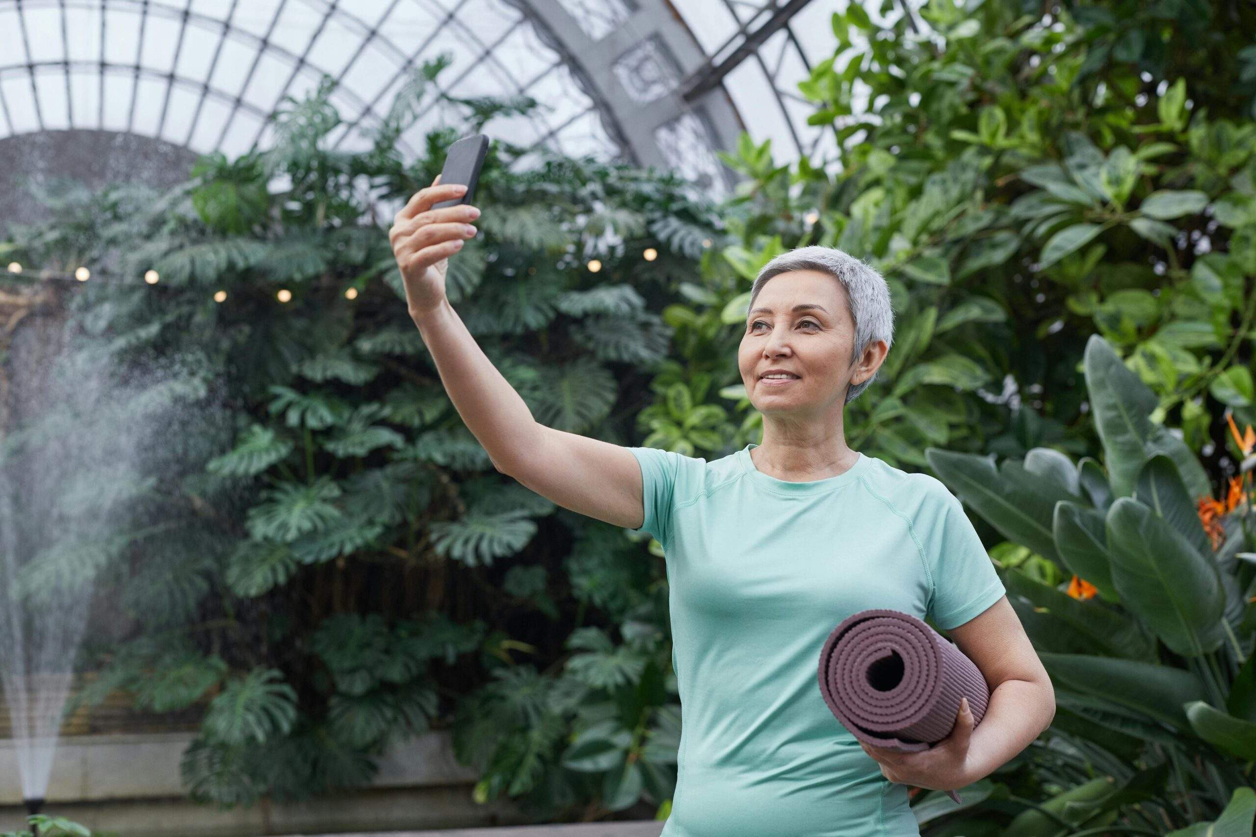 Sarah standing beside her urban garden setup filled with skincare plants