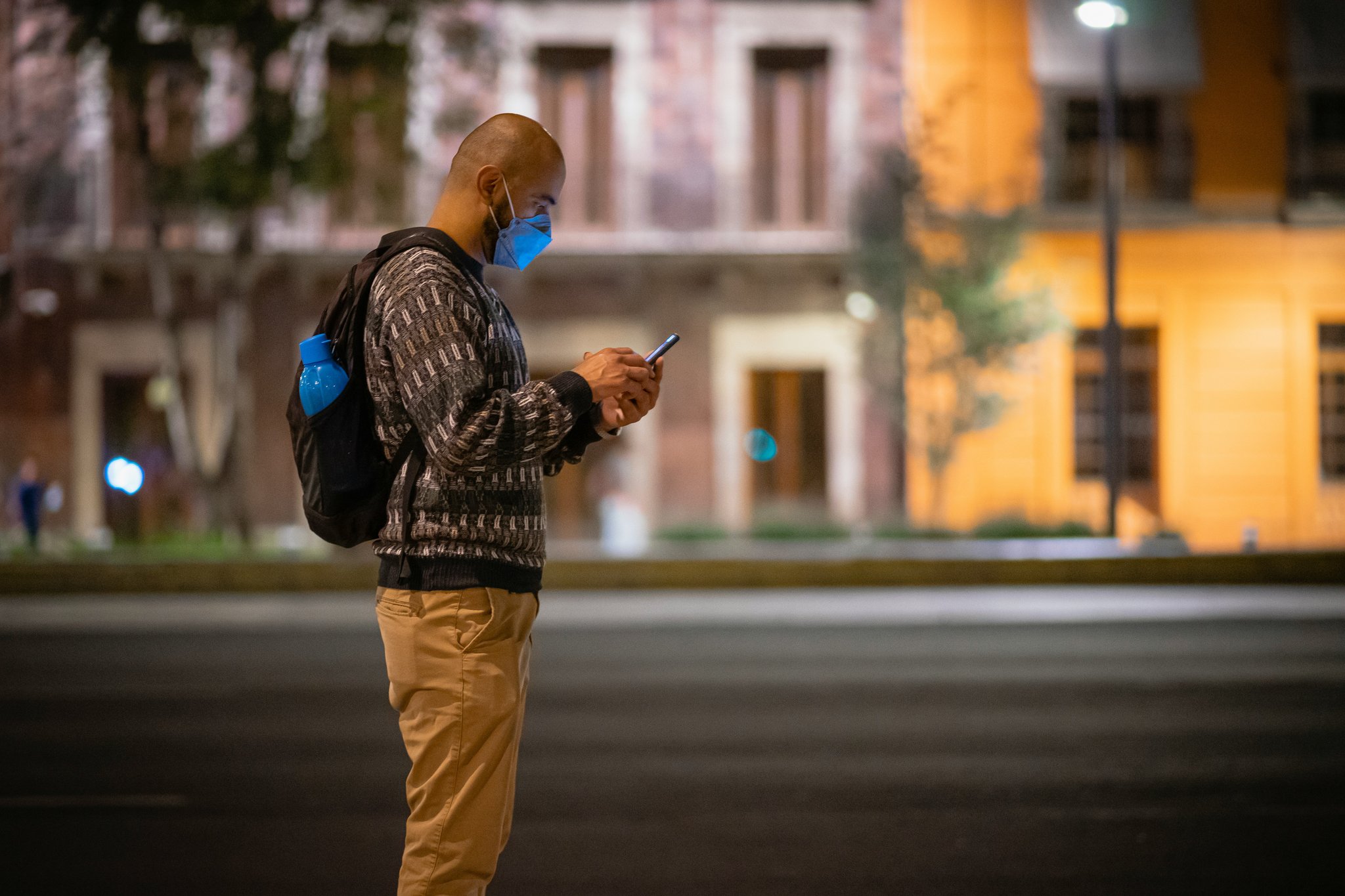 A bowl of crushed mint leaves beside a homemade mint toner bottle